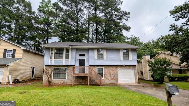 2168 Sara Ashley Way, Lithonia, GA 30058 - raised ranch with driveway, a front lawn, a garage, and stone siding
