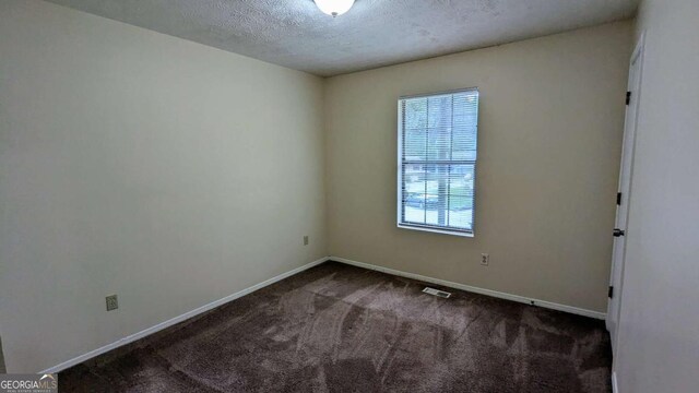 2168 Sara Ashley Way, Lithonia, GA 30058 - carpeted empty room featuring baseboards and a textured ceiling