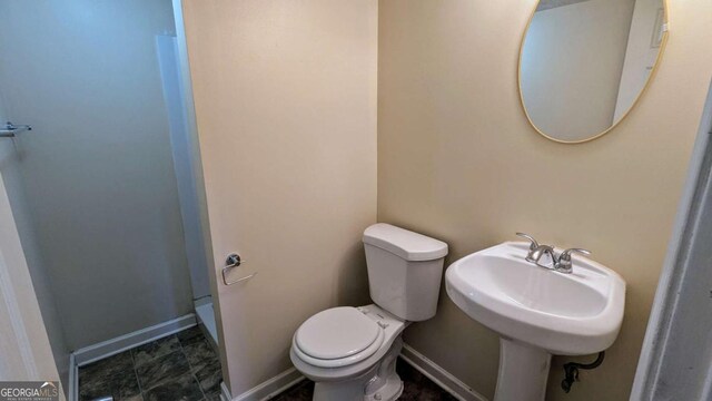 2168 Sara Ashley Way, Lithonia, GA 30058 - bathroom featuring toilet and baseboards