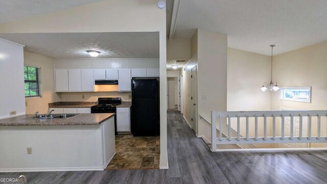 2168 Sara Ashley Way, Lithonia, GA 30058 - kitchen with black appliances, dark wood-style flooring, white cabinetry, decorative light fixtures, and under cabinet range hood