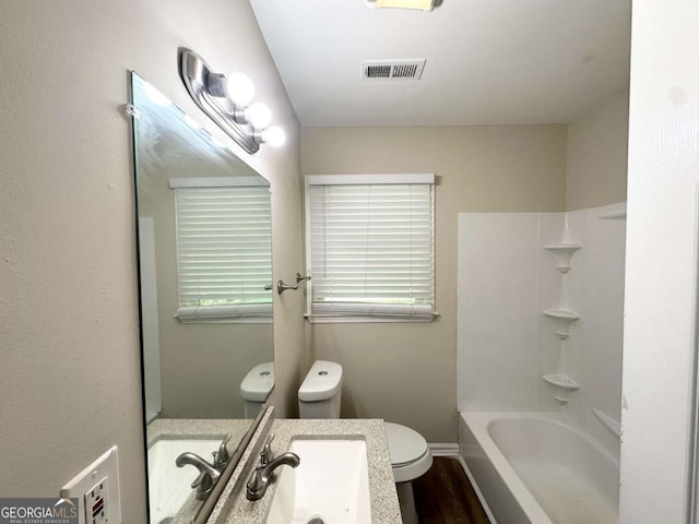 2469 Baywood Dr SE, Atlanta, GA 30315 - full bathroom with toilet, wood finished floors, vanity, shower / washtub combination, and baseboards