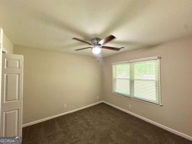 2469 Baywood Dr SE, Atlanta, GA 30315 - empty room featuring a ceiling fan, baseboards, and dark carpet