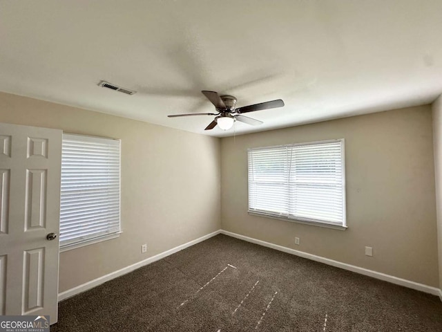 2469 Baywood Dr SE, Atlanta, GA 30315 - spare room with ceiling fan, baseboards, and dark carpet