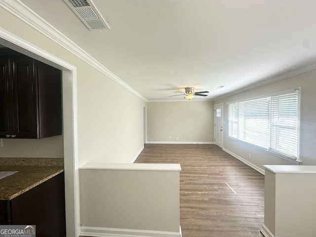 2469 Baywood Dr SE, Atlanta, GA 30315 - empty room featuring ceiling fan, crown molding, light wood-style floors, and baseboards