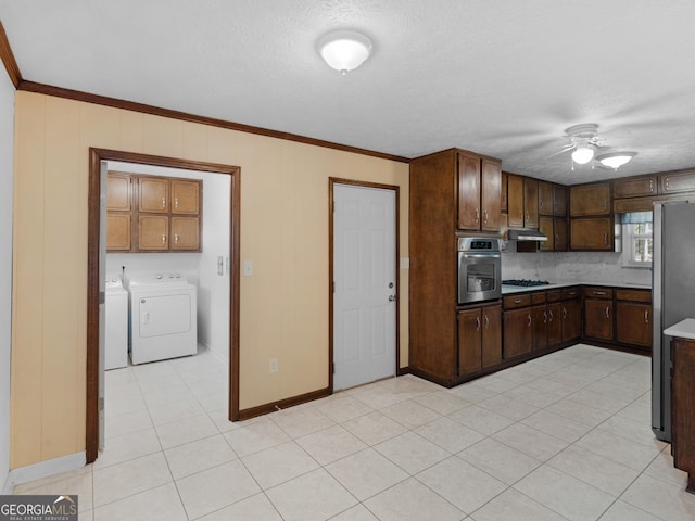 1001 Stagecoach Rd, Stockbridge, GA 30281 - kitchen with appliances with stainless steel finishes, a ceiling fan, washing machine and clothes dryer, ornamental molding, and baseboards