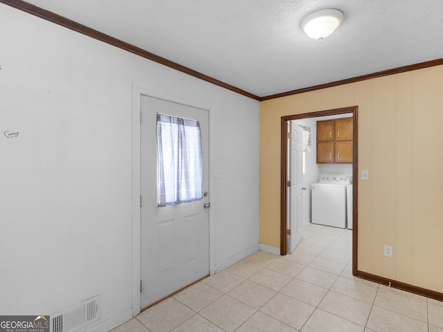 1001 Stagecoach Rd, Stockbridge, GA 30281 - empty room with washer / dryer, ornamental molding, a textured ceiling, baseboards, and light tile patterned flooring