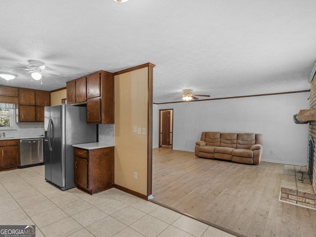 1001 Stagecoach Rd, Stockbridge, GA 30281 - kitchen featuring appliances with stainless steel finishes, a ceiling fan, light countertops, baseboards, and ornamental molding