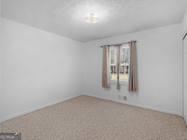 1001 Stagecoach Rd, Stockbridge, GA 30281 - carpeted empty room with a textured ceiling and baseboards