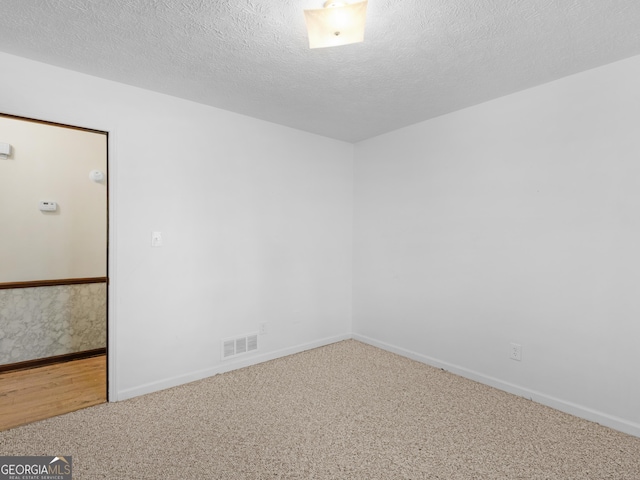 1001 Stagecoach Rd, Stockbridge, GA 30281 - spare room with carpet flooring, baseboards, and a textured ceiling