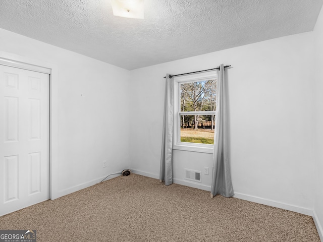 1001 Stagecoach Rd, Stockbridge, GA 30281 - unfurnished room with carpet flooring, a textured ceiling, and baseboards