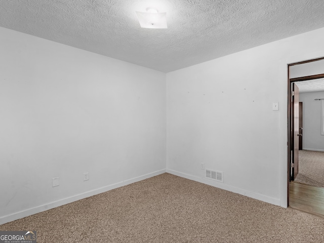 1001 Stagecoach Rd, Stockbridge, GA 30281 - spare room featuring carpet, a textured ceiling, and baseboards