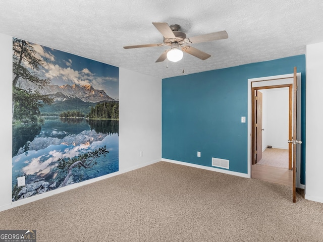1001 Stagecoach Rd, Stockbridge, GA 30281 - spare room with carpet, a textured ceiling, a ceiling fan, and baseboards