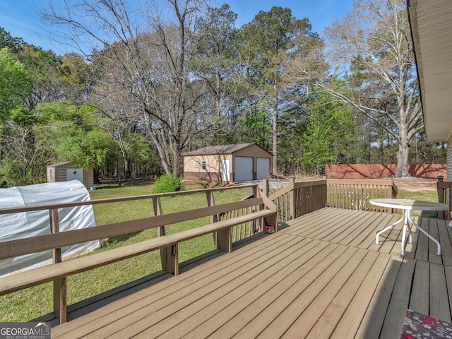 1001 Stagecoach Rd, Stockbridge, GA 30281 - deck featuring a detached garage, a yard, and view of wooded area