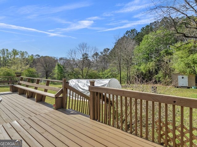 1001 Stagecoach Rd, Stockbridge, GA 30281 - wooden deck featuring a storage shed and view of wooded area