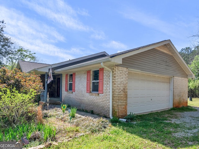 1001 Stagecoach Rd, Stockbridge, GA 30281 - view of side of home with brick siding and a garage
