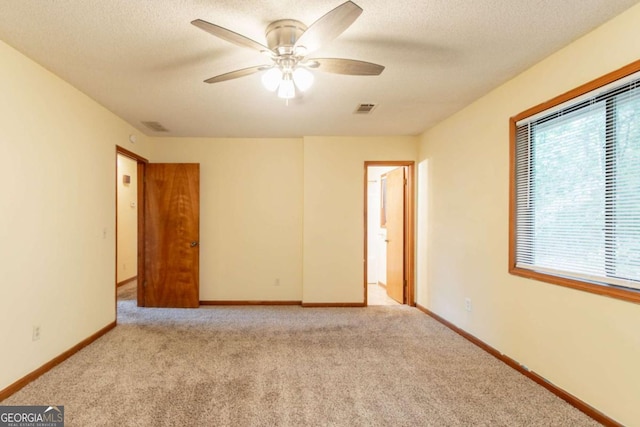 3440 Quinn Ridge Dr, Snellville, GA 30039 - carpeted empty room featuring healthy amount of natural light, a ceiling fan, and a textured ceiling
