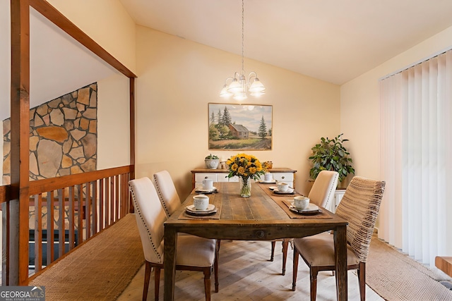 3440 Quinn Ridge Dr, Snellville, GA 30039 - dining space with a chandelier, lofted ceiling, and wood finished floors