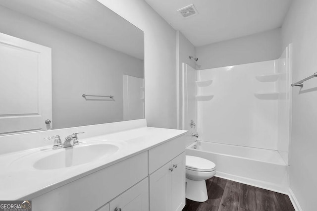 1998 Nuthatch Dr, Hoschton, GA 30548 - bathroom featuring vanity, toilet, wood finished floors, and shower / tub combination