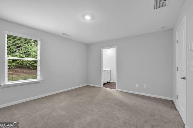 1998 Nuthatch Dr, Hoschton, GA 30548 - unfurnished bedroom featuring carpet flooring, baseboards, and connected bathroom
