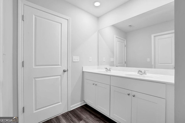 1998 Nuthatch Dr, Hoschton, GA 30548 - bathroom featuring double vanity, wood finished floors, and baseboards