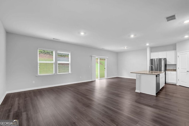 1998 Nuthatch Dr, Hoschton, GA 30548 - unfurnished living room featuring a sink, recessed lighting, baseboards, and dark wood-style flooring