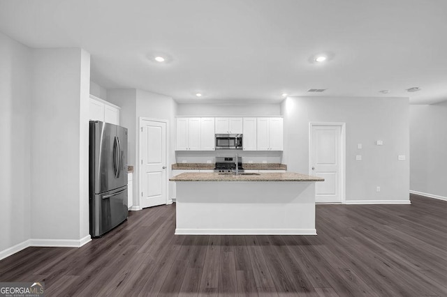 1998 Nuthatch Dr, Hoschton, GA 30548 - kitchen featuring appliances with stainless steel finishes, baseboards, dark wood-type flooring, a sink, and white cabinets