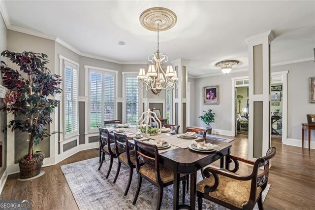 3665 Pennington Rd, Cumming, GA 30041 - dining space featuring a chandelier, dark wood-style floors, ornamental molding, and baseboards