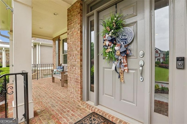 3665 Pennington Rd, Cumming, GA 30041 - view of exterior entry with a porch and brick siding