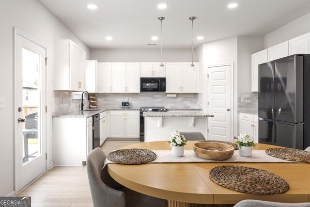 187 Lyndhurst Dr, Bethlehem, GA 30620 - kitchen with appliances with stainless steel finishes, decorative backsplash, recessed lighting, white cabinetry, and light wood finished floors