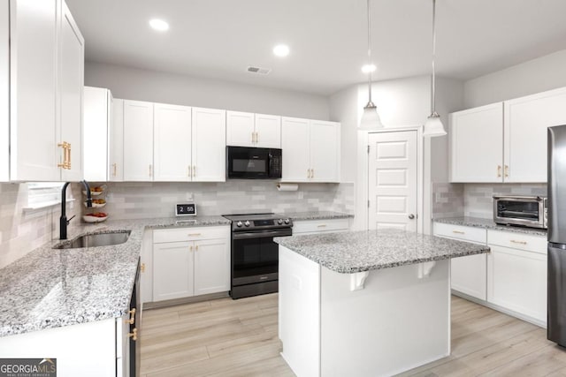 187 Lyndhurst Dr, Bethlehem, GA 30620 - kitchen with stainless steel appliances, backsplash, a center island, white cabinetry, and light stone countertops