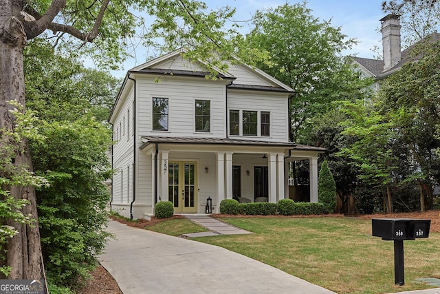 357 Mell Ave Unit A, Atlanta, GA 30307 - view of front facade featuring a standing seam roof, french doors, a front lawn, and metal roof