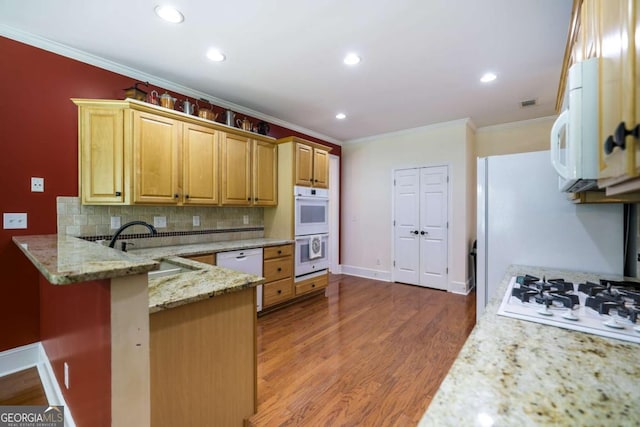 1997 Shaker Falls Ln, Lawrenceville, GA 30045 - kitchen featuring white appliances, crown molding, a sink, a peninsula, and decorative backsplash