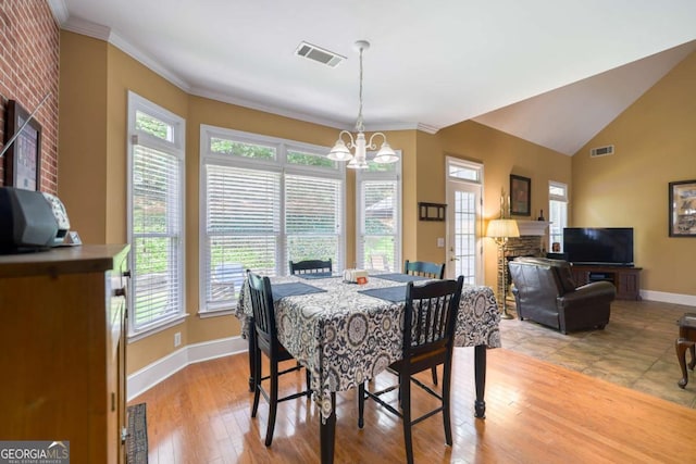 1997 Shaker Falls Ln, Lawrenceville, GA 30045 - dining room featuring baseboards, plenty of natural light, a chandelier, crown molding, and light wood finished floors