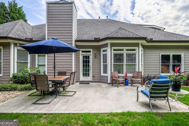1997 Shaker Falls Ln, Lawrenceville, GA 30045 - back of property featuring a patio, a chimney, and a shingled roof