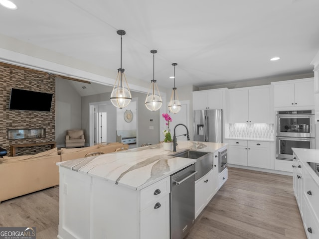 319 S Mount Carmel Rd, Mcdonough, GA 30253 - kitchen featuring stainless steel appliances, open floor plan, white cabinetry, a kitchen island with sink, and recessed lighting