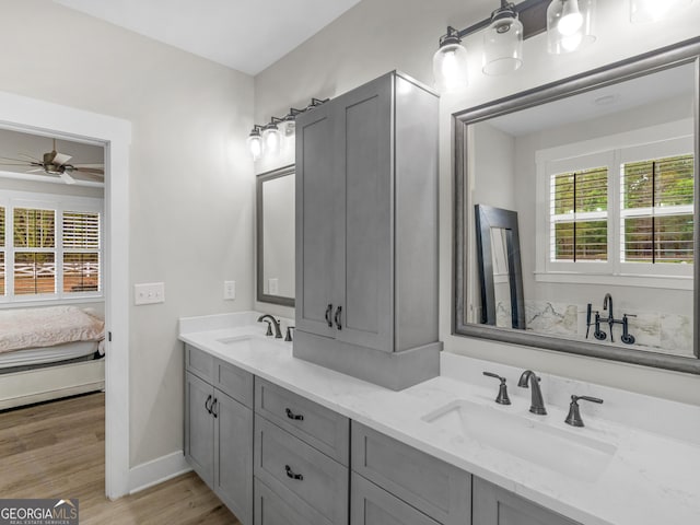 319 S Mount Carmel Rd, Mcdonough, GA 30253 - ensuite bathroom with double vanity, a ceiling fan, wood finished floors, and baseboards
