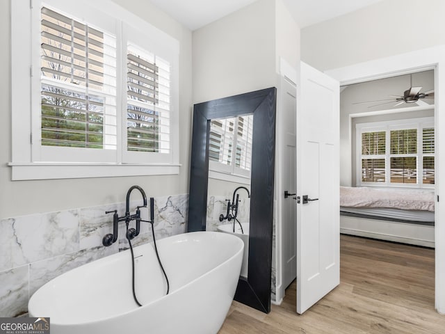 319 S Mount Carmel Rd, Mcdonough, GA 30253 - ensuite bathroom with a freestanding tub, wood finished floors, and ceiling fan