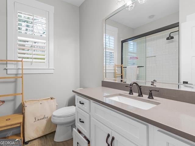 319 S Mount Carmel Rd, Mcdonough, GA 30253 - bathroom with vanity, a tile shower, toilet, and wood finished floors