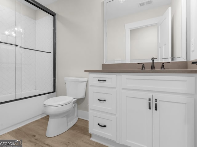 319 S Mount Carmel Rd, Mcdonough, GA 30253 - full bath with toilet, combined bath / shower with glass door, vanity, wood finished floors, and baseboards