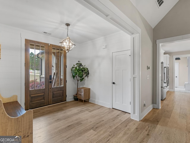 319 S Mount Carmel Rd, Mcdonough, GA 30253 - foyer entrance with light wood-style floors, french doors, a chandelier, baseboards, and lofted ceiling