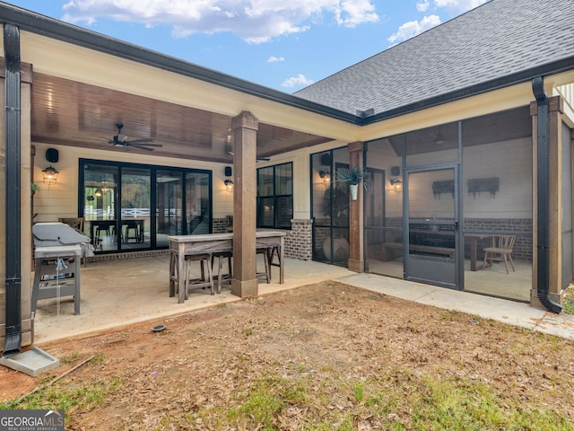 319 S Mount Carmel Rd, Mcdonough, GA 30253 - back of house with ceiling fan, a shingled roof, a patio, outdoor dining space, and brick siding