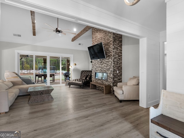 319 S Mount Carmel Rd, Mcdonough, GA 30253 - living room with wood finished floors, ceiling fan, beam ceiling, high vaulted ceiling, and a fireplace