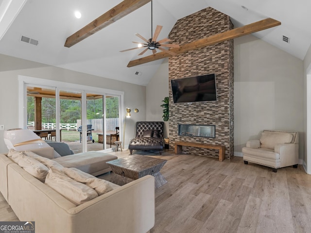 319 S Mount Carmel Rd, Mcdonough, GA 30253 - living area featuring high vaulted ceiling, ceiling fan, beamed ceiling, wood finished floors, and a fireplace