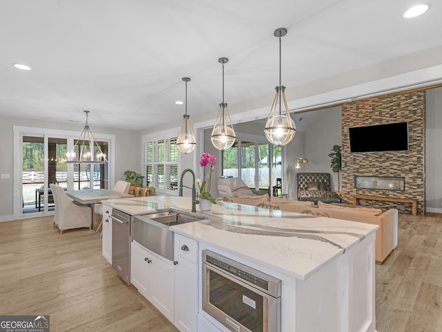319 S Mount Carmel Rd, Mcdonough, GA 30253 - kitchen featuring a sink, open floor plan, a kitchen island with sink, white cabinets, and recessed lighting
