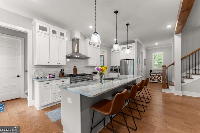 4847 Destitute Way, Gainesville, GA 30506 - kitchen featuring wall chimney range hood, a sink, appliances with stainless steel finishes, light wood finished floors, and tasteful backsplash