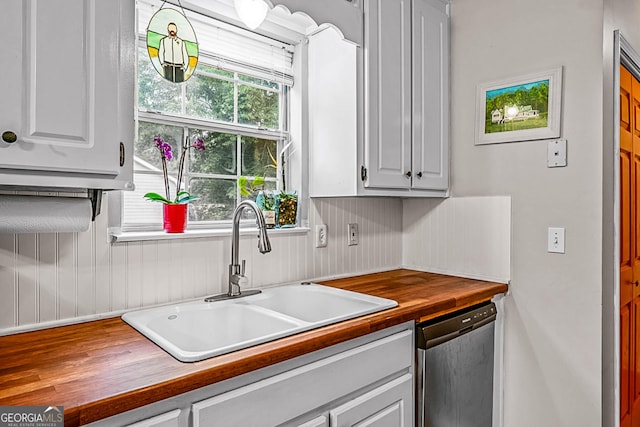 161 Mills Dr, Covington, GA 30016 - kitchen with a sink, dishwasher, butcher block counters, and white cabinets