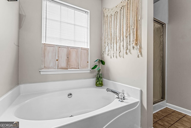 161 Mills Dr, Covington, GA 30016 - full bathroom featuring a bath, tile patterned flooring, and an enclosed shower