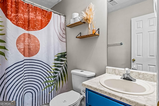 161 Mills Dr, Covington, GA 30016 - bathroom with a textured ceiling, vanity, toilet, and a shower with shower curtain