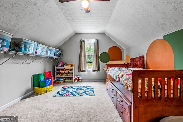 161 Mills Dr, Covington, GA 30016 - bedroom featuring baseboards, carpet, vaulted ceiling, a ceiling fan, and a textured ceiling