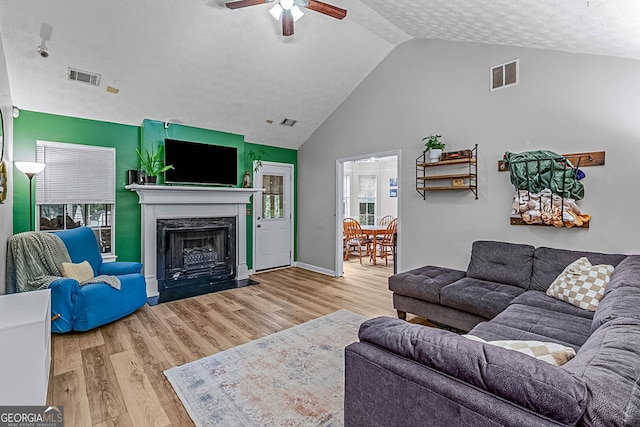 161 Mills Dr, Covington, GA 30016 - living room featuring a ceiling fan, a premium fireplace, wood finished floors, baseboards, and high vaulted ceiling